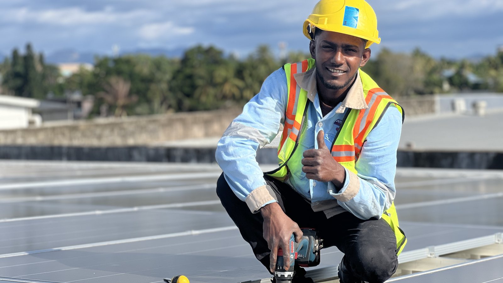 Solar Hub Fiji installer on the Rosie Holidays commercial rooftop solar array
