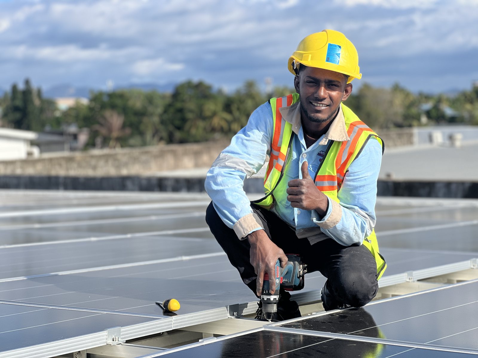 A Solar Hub Fiji installer on the Rosie Holidays commercial rooftop array