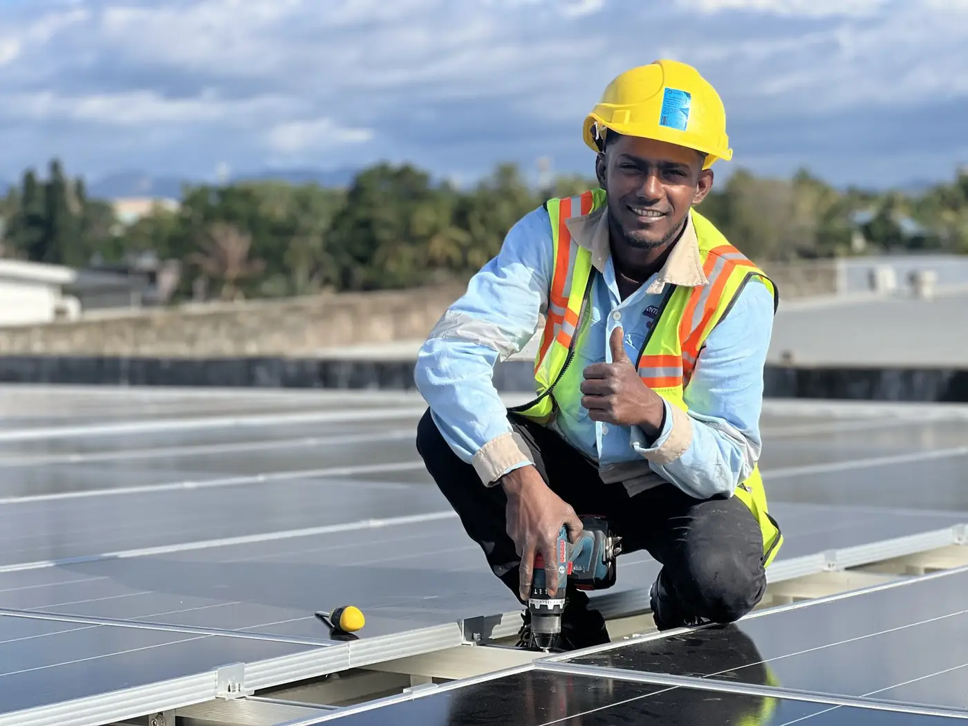 A Solar Hub Fiji installer on the Rosie Holidays commercial rooftop array