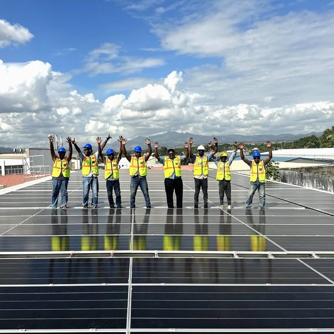 The Solar Hub Fiji install crew on the completed Rosie Holidays rooftop solar array