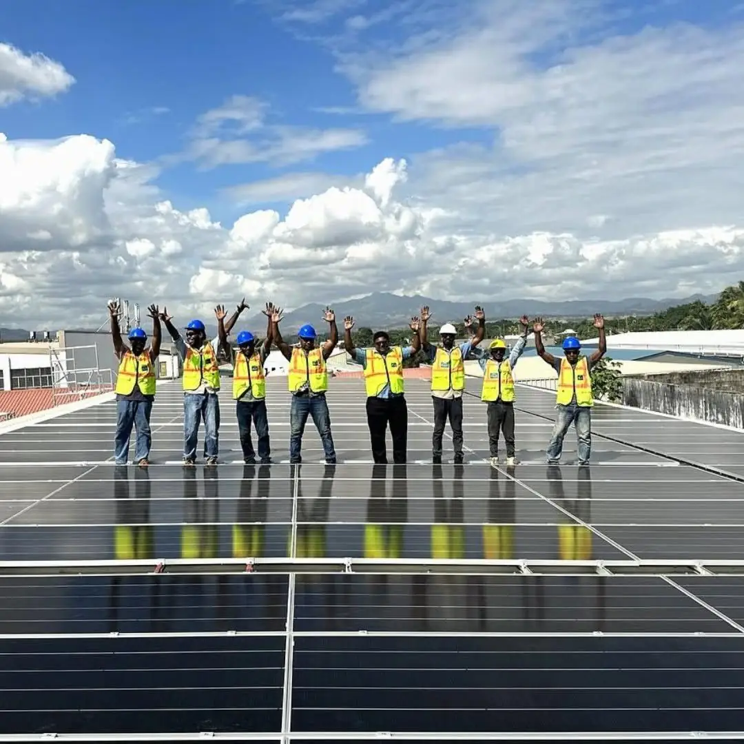 The Solar Hub Fiji install crew on the completed Rosie Holidays rooftop solar array