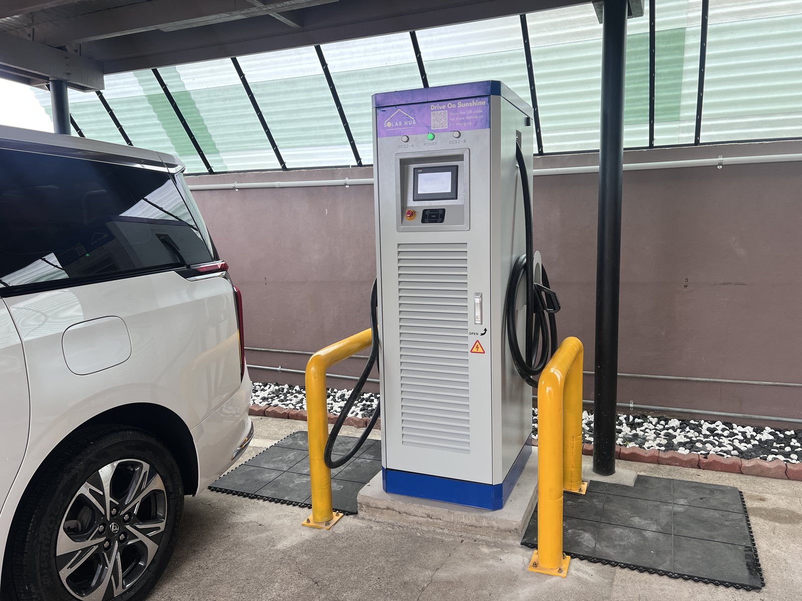 A Solar Hub Fiji DC fast EV charger charging an electric vehicle
