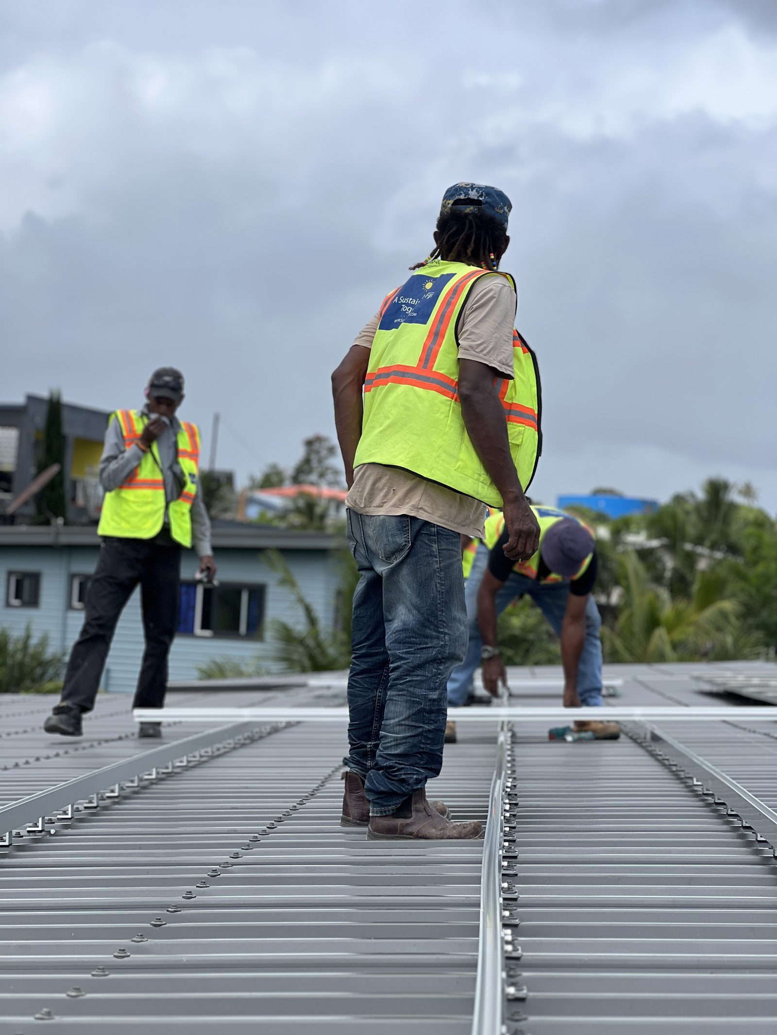 Solar Hub Fiji crew at work on a roof