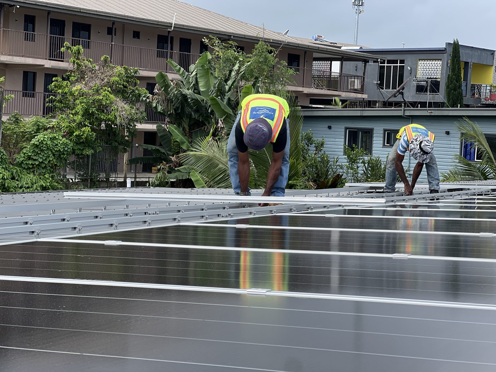 Solar Hub Fiji crew installing mounting rails