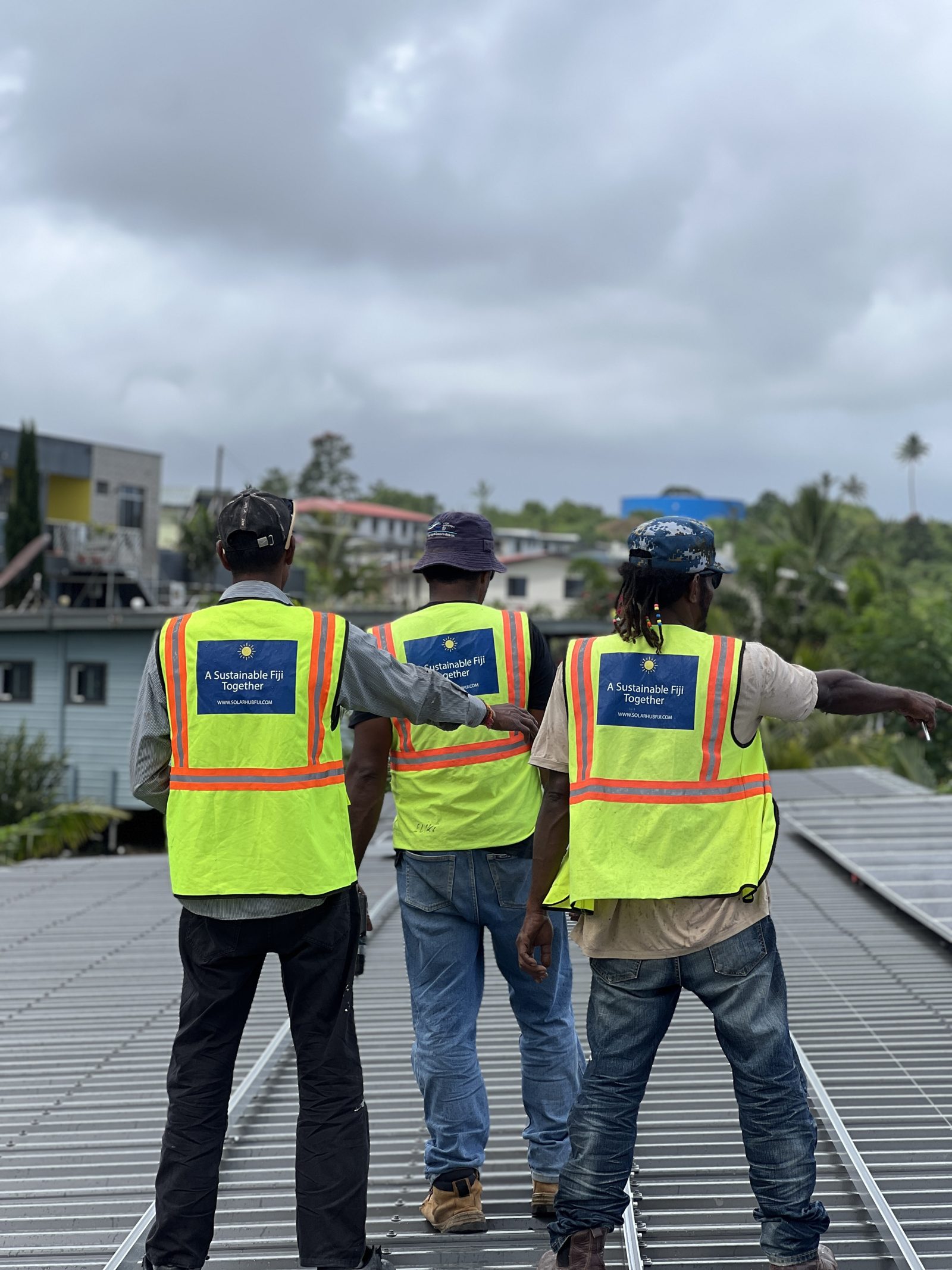 Solar Hub Fiji install crew on a rooftop